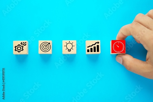 Business process management, Businessman plan a project with wooden cubes with icon business strategy on blue background. © theserhat