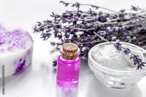 organic cosmetic with lavender flowers and oil on white background
