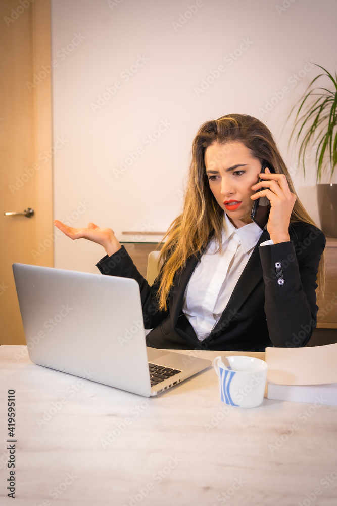 Difficulties of teleworking at home during the coronavirus pandemic, young blonde Caucasian woman with a coffee working with the computer Difficulties of teleworking at home during the coronavirus pandemic, young blonde Caucasian woman with a coffee working with the computer