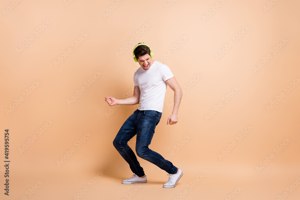 Full body photo of astonished handsome guy open mouth shout closed eyes isolated on beige color background Full body photo of astonished handsome guy open mouth shout closed eyes isolated on beige color background