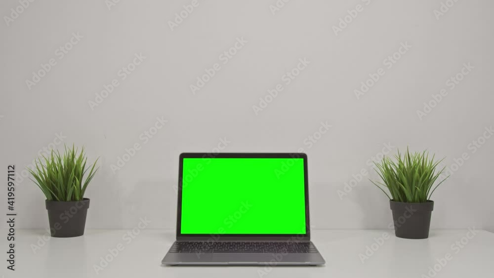 4K Green screen of laptop computer set on working space in cozy office, Zoom in shot 4K Green screen of laptop computer set on working space in cozy office, Zoom in shot