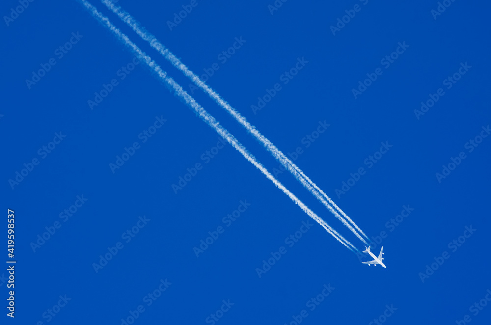 Airplane descending is removed leaving a white contrails behind it