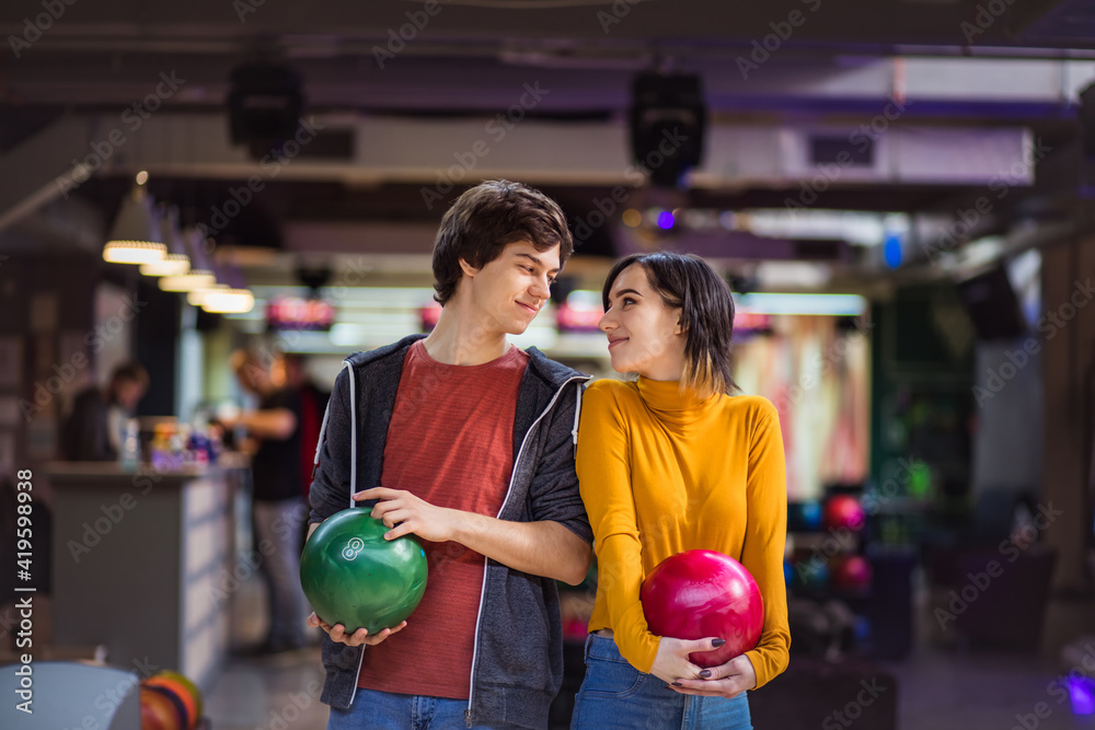 Fototapeta premium Young couple having fun in bowling alley.