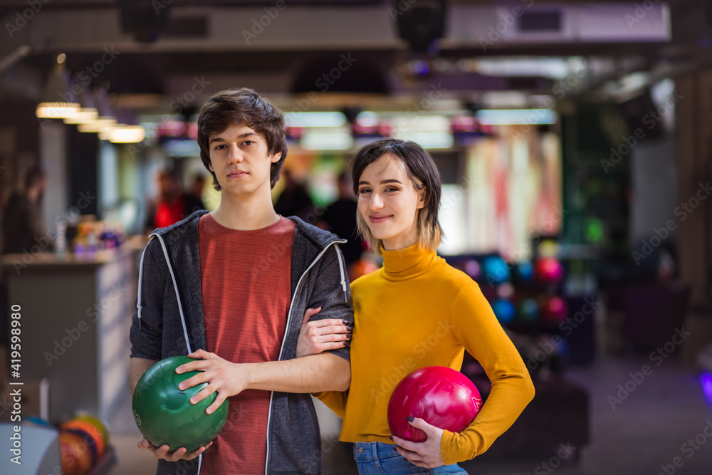 Fototapeta premium Portrait of young couple in bowling alley.