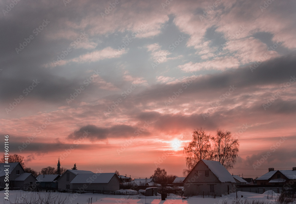 Evening winter sunset in the village