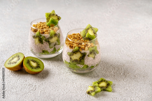 Chia pudding with kiwi on grey background. Healthy nutrition, superfood. Closeup view.