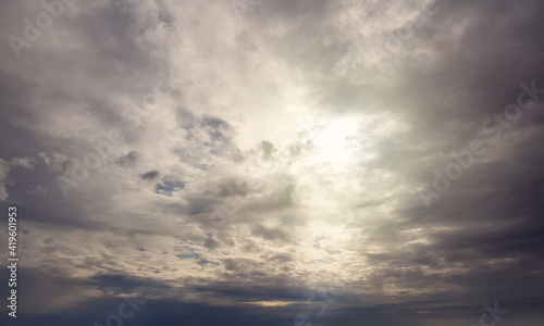 Thunderclouds and sunbeam on sky