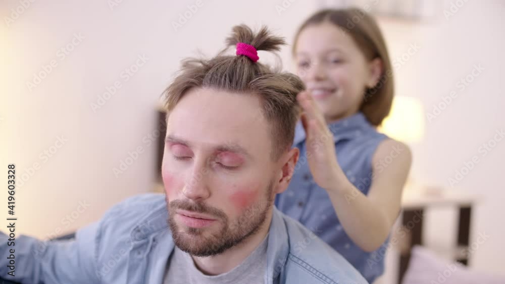 Daughter playing with patient dad, hairstyle and make-up, family connection