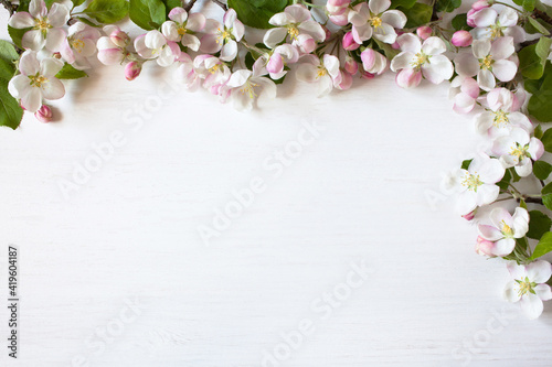 Spring white wooden background with apple tree flowers and space for text.