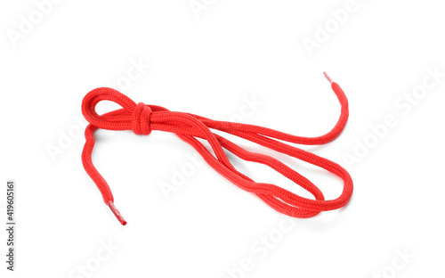 Red shoe lace tied in knot isolated on white
