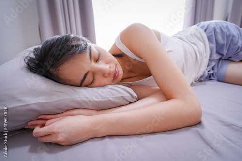 Image closeup of cute young Asian woman sleeping in grey bed , In the morning