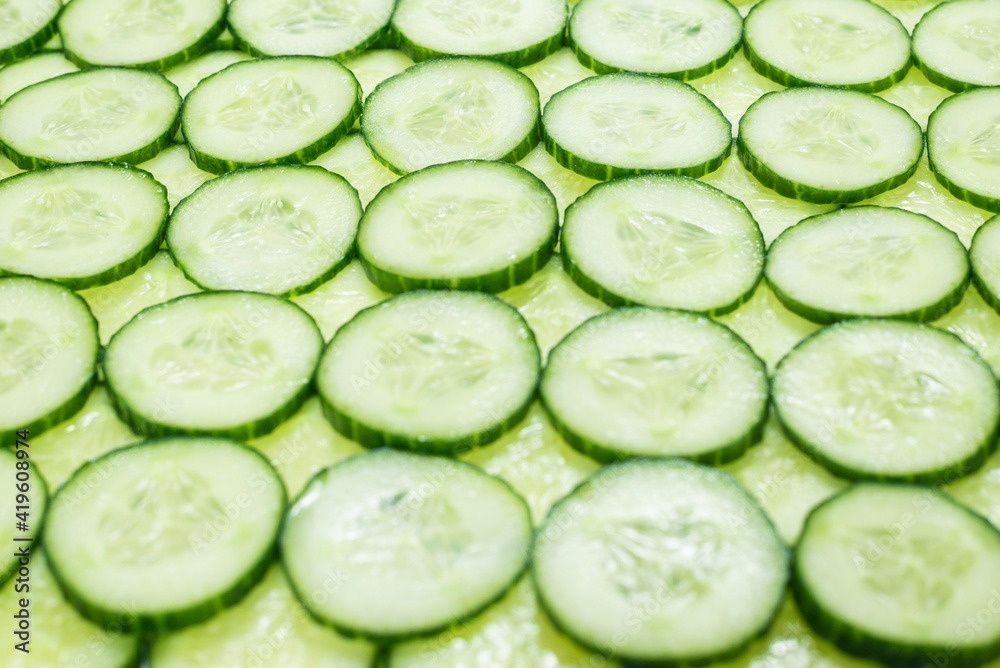 Fresh green slices of cucumber as background. Fresh green slices of cucumber as background.