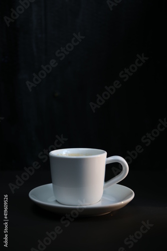 a cup of coffee on a dark background