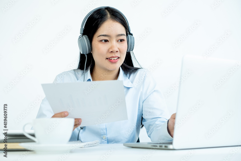 Asian female accountant sits at their desks and calculates financial graphs showing results about their investments, plan a successful business growth process Asian female accountant sits at their desks and calculates financial graphs showing results about their investments, plan a successful business growth process
