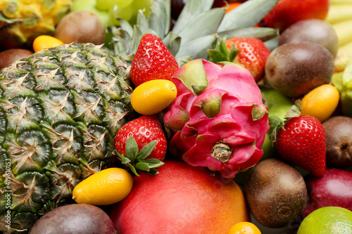 Assortment of fresh exotic fruits as background  closeup