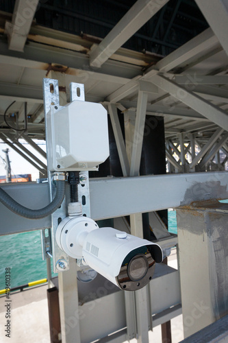 outdoor surveillance and security video camera installed on a metal structure © Ambartsumian
