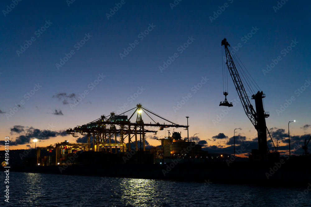 02 March 2021 Russia, Novorossiysk. International trade port with a crane for sea containers in the evening.