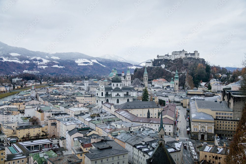 Panoramic top scenery of old town, viewpoint near museum of modern art during cloudy and gloomy winter day, river Salzach, Kapuzinerberg, Hohensalzburg Fortress, Salzburg, Austria