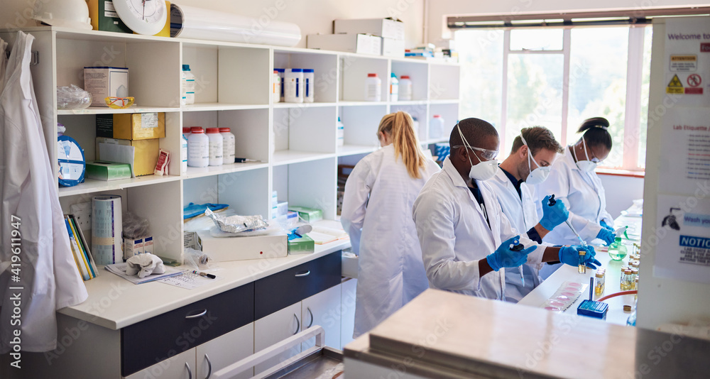 Diverse group of technicians analyzing samples in a lab