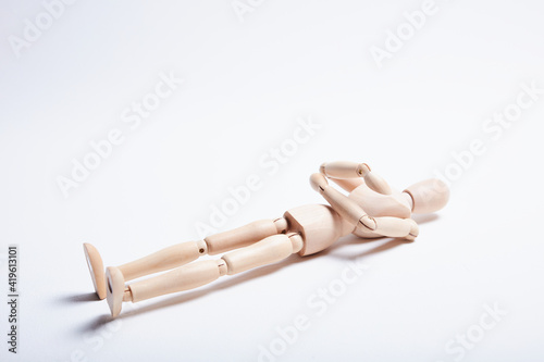 wooden mannequin in different poses on a white background