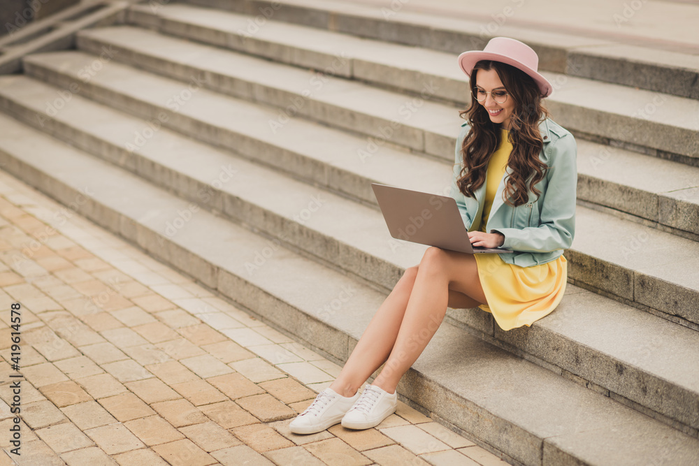 Photo of adorable cute young lady wear turquoise jacket communicating modern device sitting stairs outside urban city Photo of adorable cute young lady wear turquoise jacket communicating modern device sitting stairs outside urban city