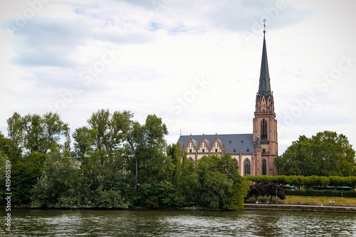 Church of the Three Kings or Dreikonigskirche, Lutheran Protestant church and parish, Gothic revival style, bell tower, trees green leaves, sunny summer day Frankfurt am Main, Germany
