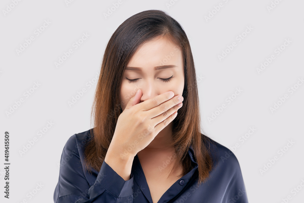 Portrait of tired girl who yawns. A woman yawning on a light gray background Portrait of tired girl who yawns. A woman yawning on a light gray background