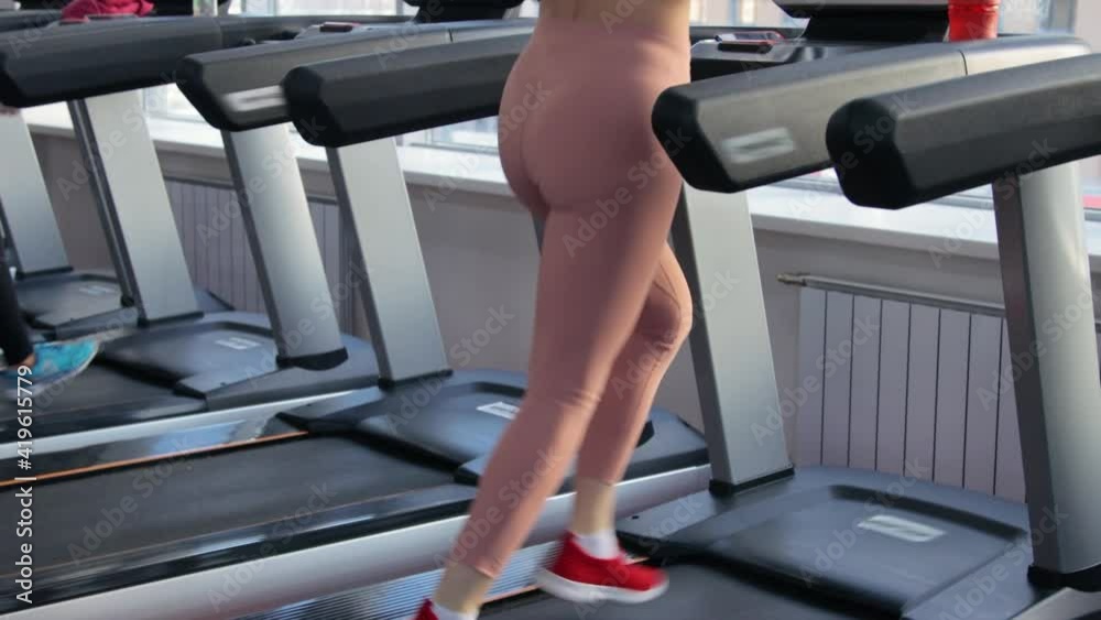 Young woman training on treadmill