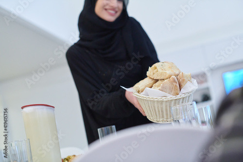 Young muslim woman serving food for iftar during Ramadan