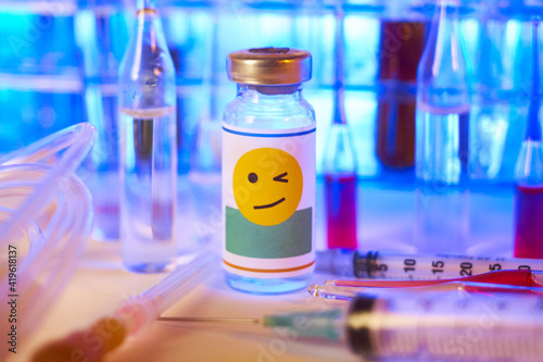 Medical ampoule (vial) with a face winking smiley label. 