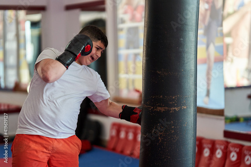 Overweight kickboxer working the heavy bag © Xalanx