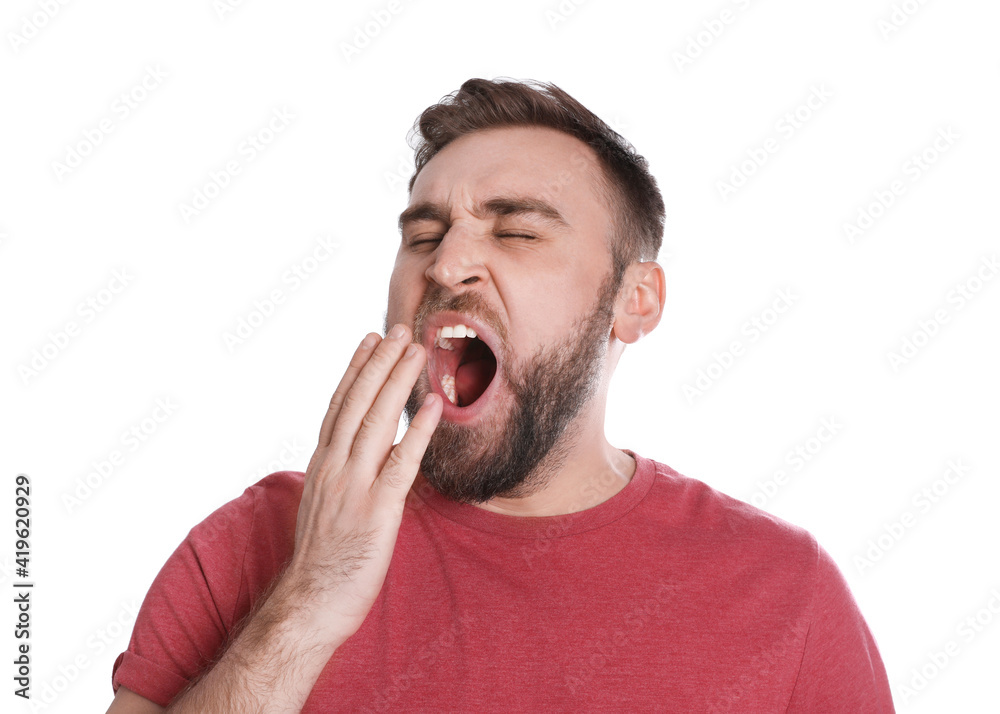 Sleepy young man yawning on white background Sleepy young man yawning on white background