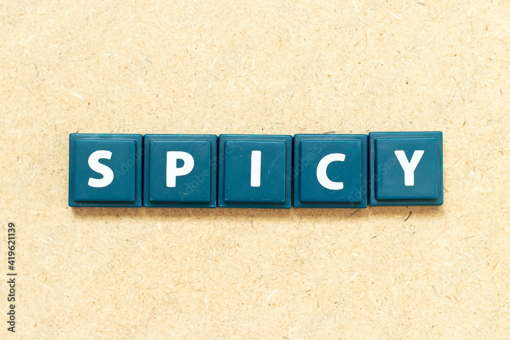Tile alphabet letter in word spicy on wood background Tile alphabet letter in word spicy on wood background