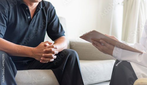 Doctor physician consulting with male patients in hospital exam room. Men's health concept photo