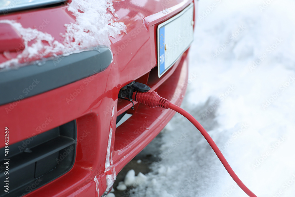 The power cord of the block heater connected to the car engine in winter  Stock Photo | Adobe Stock