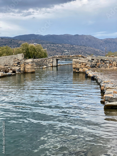 Old stouns bridge over canal , Elounda peninsula photo