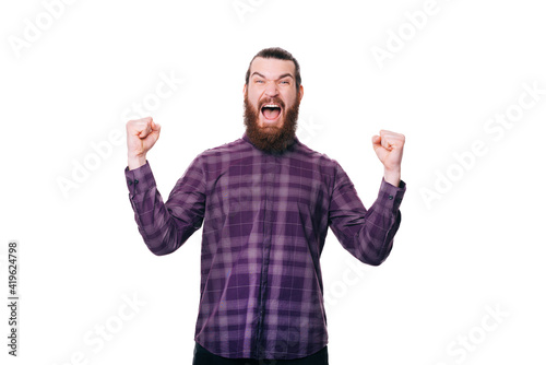 Quadro em tela Amazed young bearded man celebrating victory and screaming