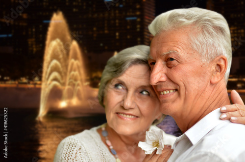 happy senior couple posing against Las Vegas city