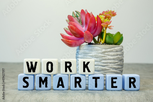 Soft cubes with the abbreviation WORK SMARTER with a flower