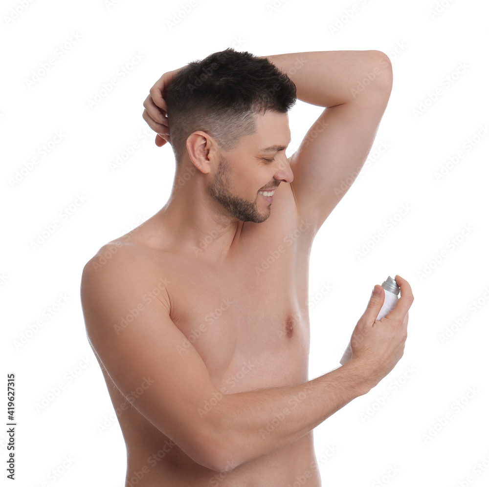 Handsome man applying deodorant isolated on white Handsome man applying deodorant isolated on white