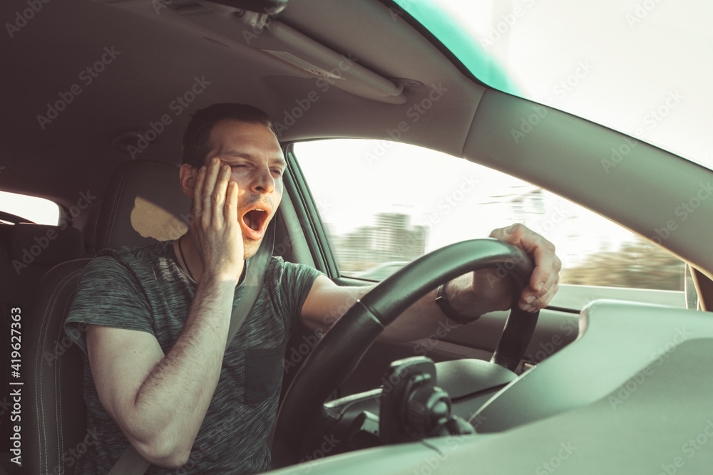 Drunk driver yawning and falling asleep rushes at high speed along road, breaking the rules and speeding violation. Drug intoxication while driving in motion. Problems and risk of accident Drunk driver yawning and falling asleep rushes at high speed along road, breaking the rules and speeding violation. Drug intoxication while driving in motion. Problems and risk of accident