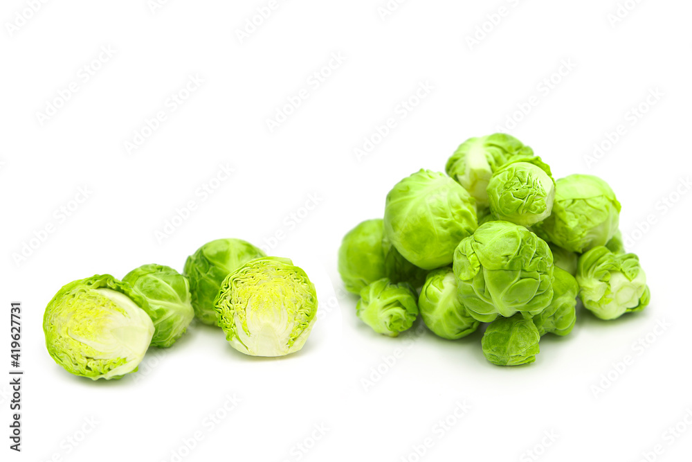 Fresh organic brussels sprouts in heap, whole and halves, isolated on white background. Fresh organic brussels sprouts in heap, whole and halves, isolated on white background.