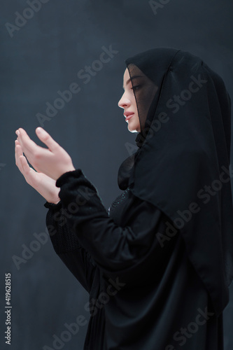 Portrait of young Muslim woman making dua