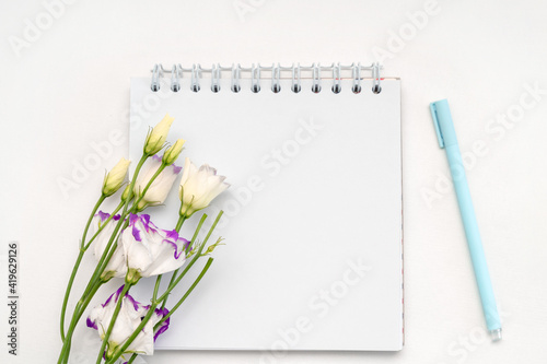 Notepad for writing and bush roses, romantic flower banner