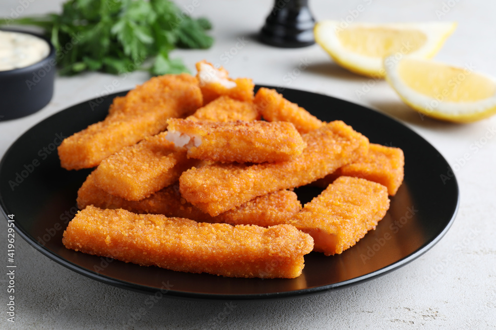 Fresh breaded fish fingers served on white table Fresh breaded fish fingers served on white table