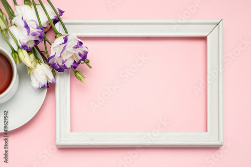 Flowers composition romantic. Spring flowers, photo frame on pastel background. Flat lay, top view, copy space © KseniaJoyg