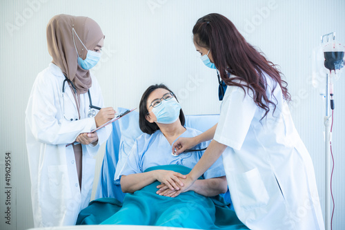 Female patients wear a surgical face mask while being in hospital, coronavirus COVID-10 flu virus protection concept