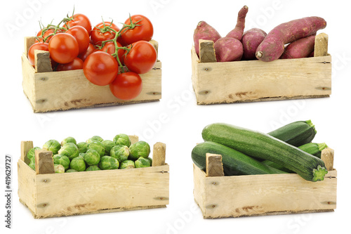 Fresh cooking vegetables in a wooden crate on a white background photo