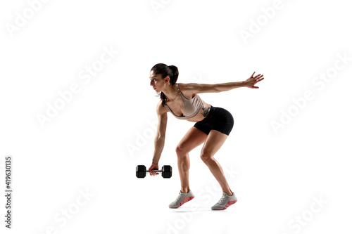 Squats with weight. Caucasian professional female athlete training isolated on white studio background. Muscular, sportive woman. Concept of action, motion, youth, healthy lifestyle. Copyspace for ad.