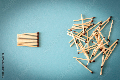 Lots of matches on a blue background. The concept of chaos and order. Selective focus.
